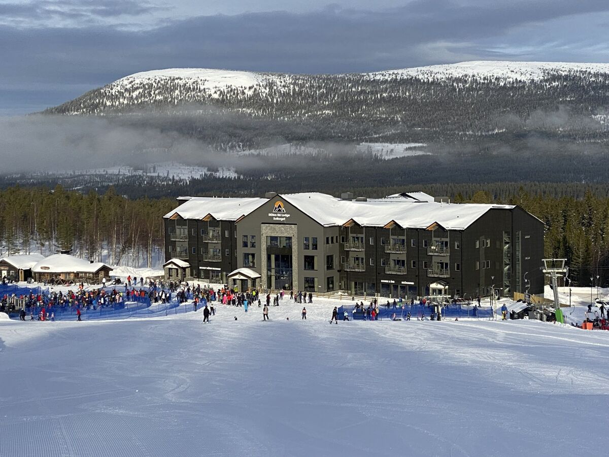 Björnrike in Sweden - a group of people skiing on a snowy slope.