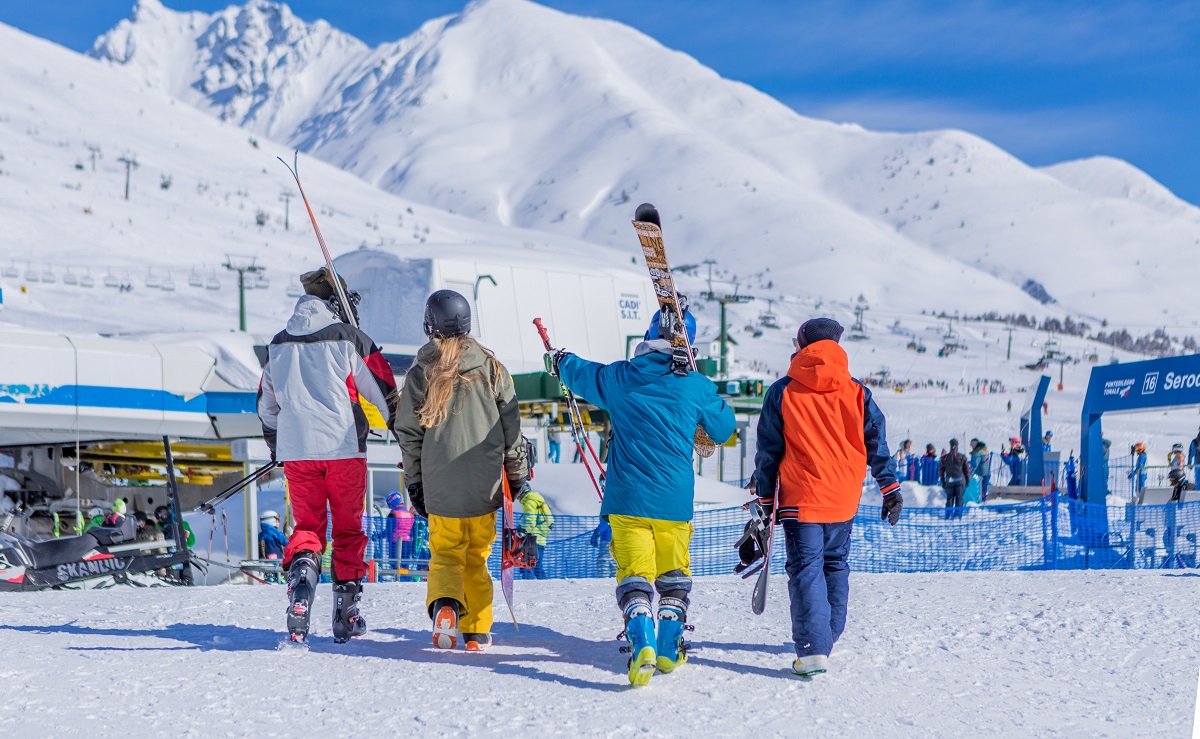 Borno – Monte Altissimo in Italy - a group of people walking down a snow covered slope.