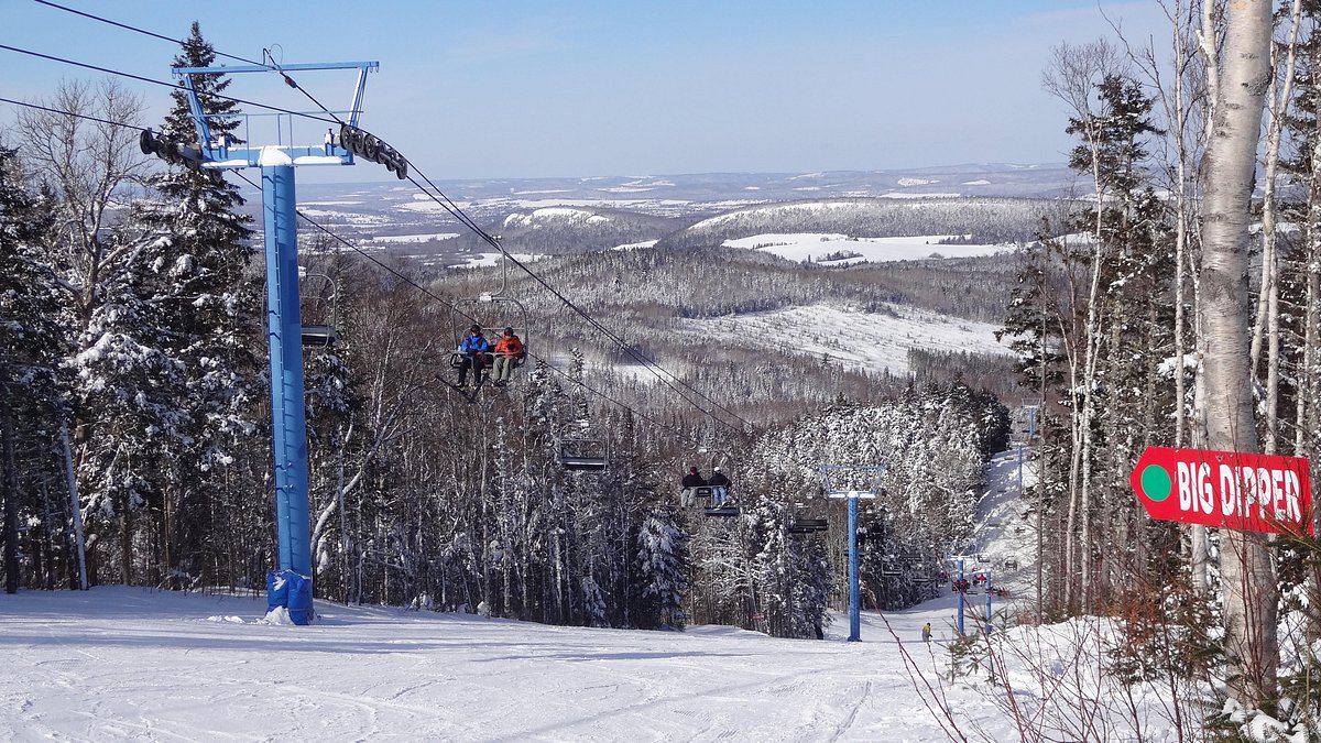 Poley Mountain in Canada - a ski lift going down a snowy slope.