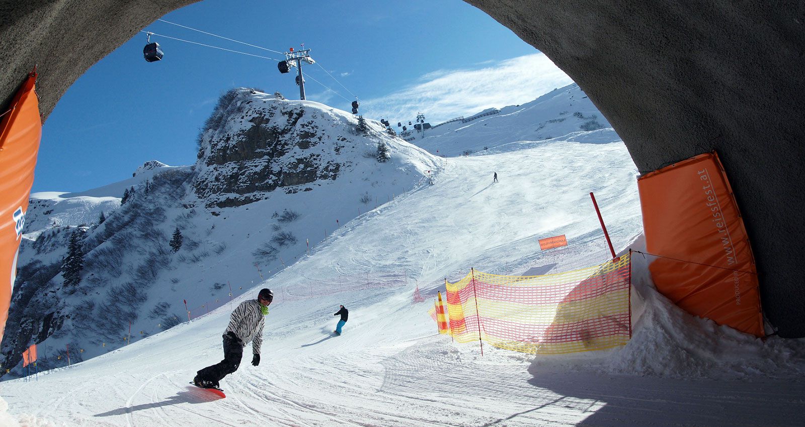 Damüls Mellau in Austria - a person on a snowboard going through a tunnel.