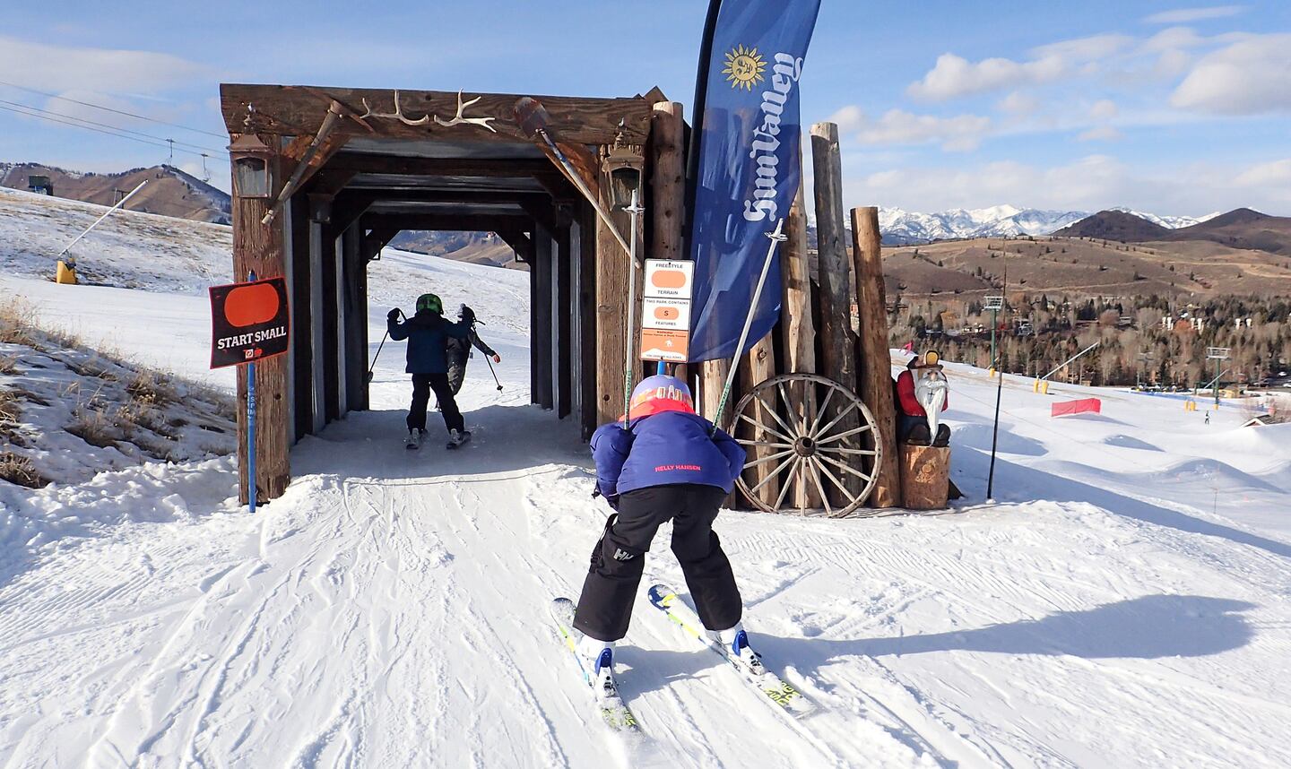 Dollar Mountain – Sun Valley in USA - a group of people skiing down a snowy slope.