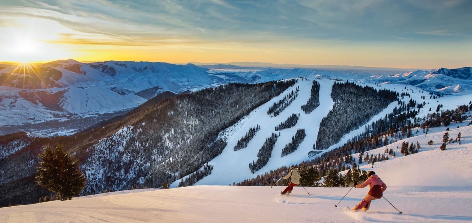 Dollar Mountain – Sun Valley in USA - a person skiing down a snowy slope at sunset.