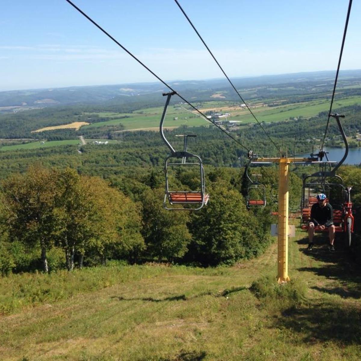 Mont Comi in Canada - a cable car going up the mountain to the top of a mountain.