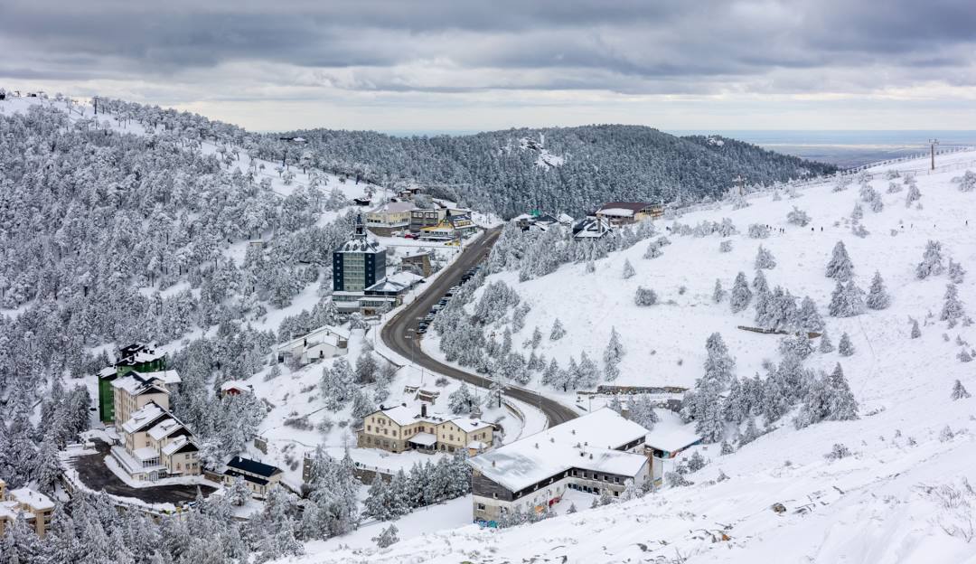 Ski resort in Puerto Navacerrada, Cercedilla, Madrid, Spain showcasing stunning winter scenery during a lively winter sports scene.