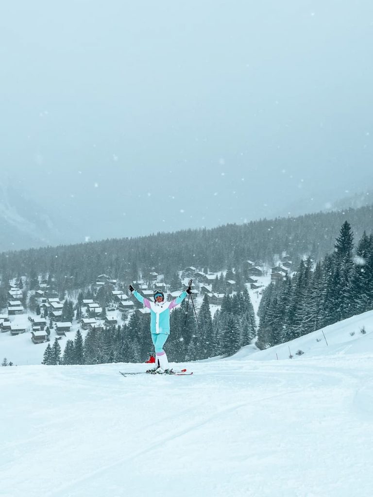 La Fouly in Switzerland - a person riding a snowboard down a snow covered slope.