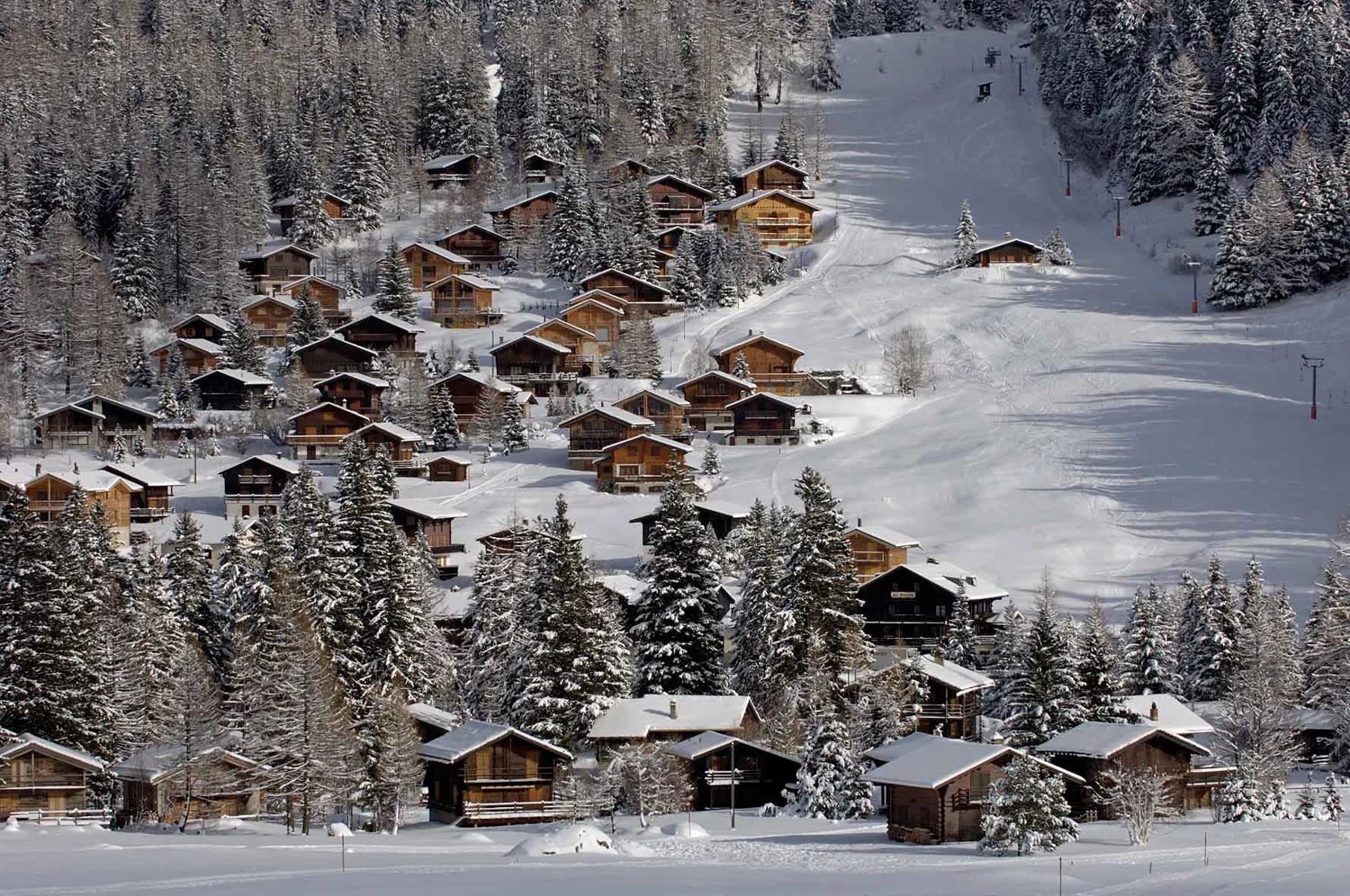 La Fouly in Switzerland: a ski resort surrounded by snow covered trees.