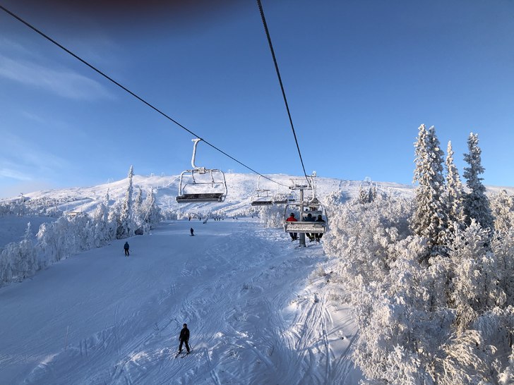 Stunning view of Trillevallen ski resort in Northern Sweden showing a ski lift against the backdrop of snow-covered slopes, offering perfect conditions for winter sports.