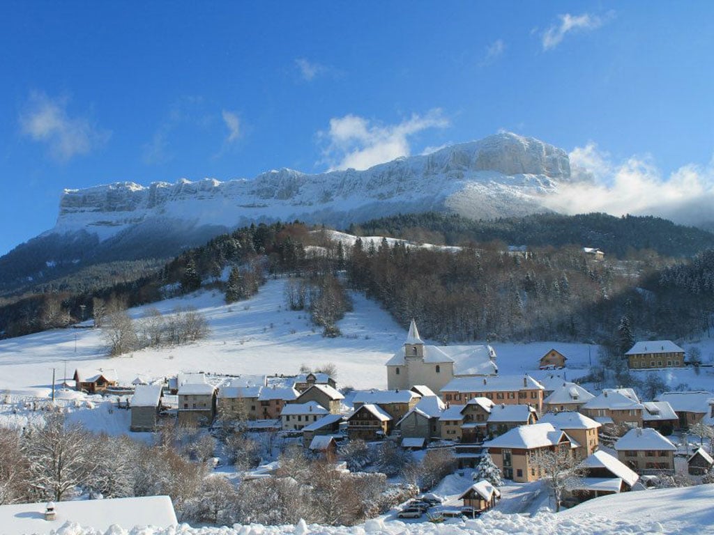 Gresse en Vercors in France - a snowy village with mountains in the background.
