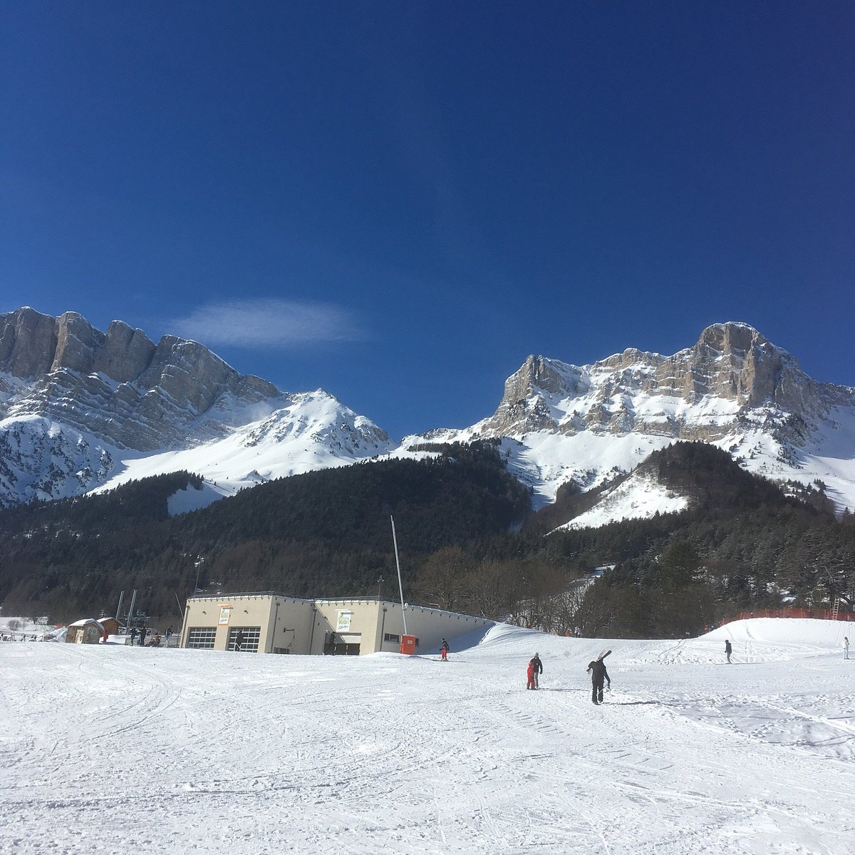 Gresse en Vercors in France - a group of people skiing down a snow covered mountain.