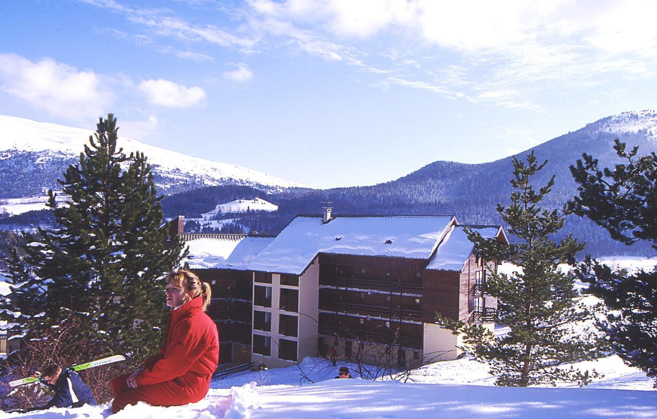 Gresse en Vercors in France - a woman sitting in the snow in front of a house.