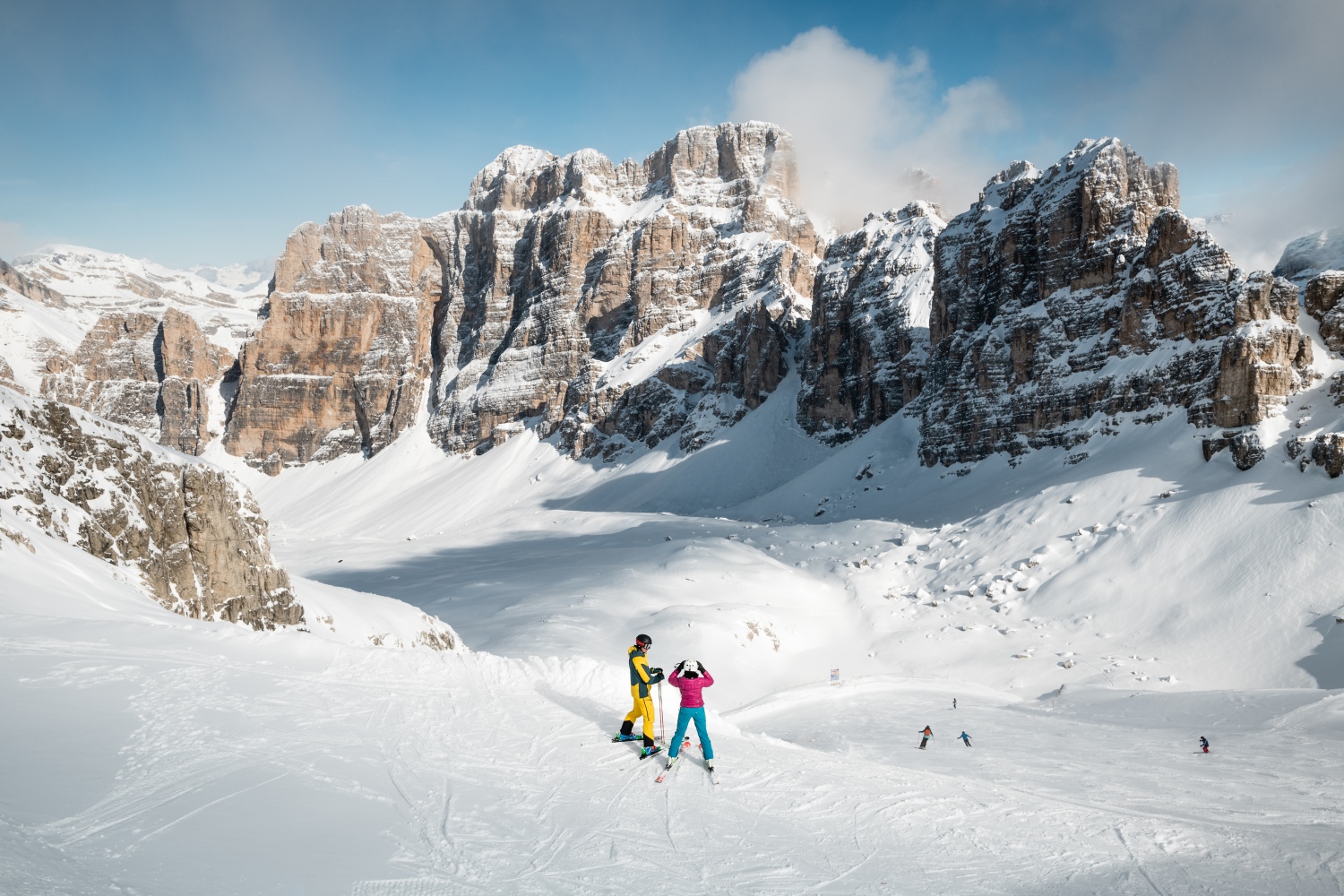 Alta Badia in Italy - a group of people skiing down a snow covered mountain.