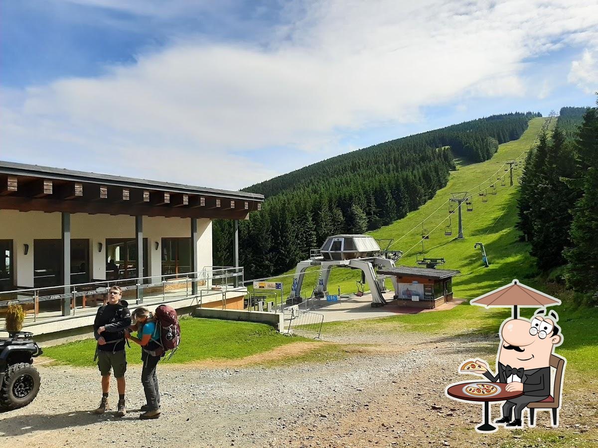 Bonera Ski areál Ramzová in Czech Republic: a group of people standing in front of a building.