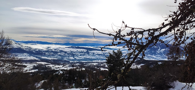 Image of a charming chalet amid a stunning winter scenery in Chaillol, France. The landscape is dominated by snow-covered mountain ranges, hinting the popularity of winter sports in the area.
