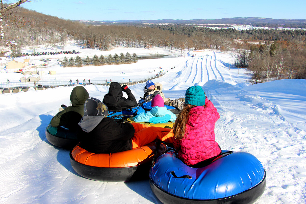 Whitetail in USA - a group of people tubling down a hill.