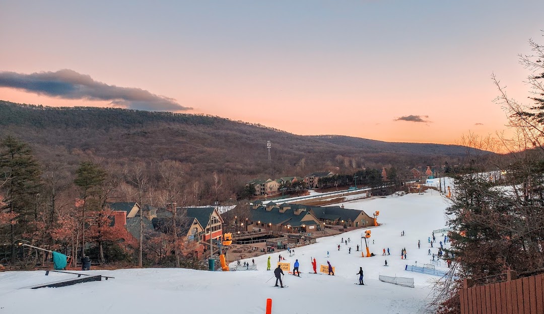 Winter sports enthusiasts enjoying their time at the Whitetail ski resort in Mercersburg, Pennsylvania. Stunning winter scenery with ski lifts in operation.