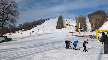 View of Shanty Creek Resorts – Schuss Mountain in Mancelona Michigan featuring a ski lift operation amidst the winter sports scene at the ski resort.