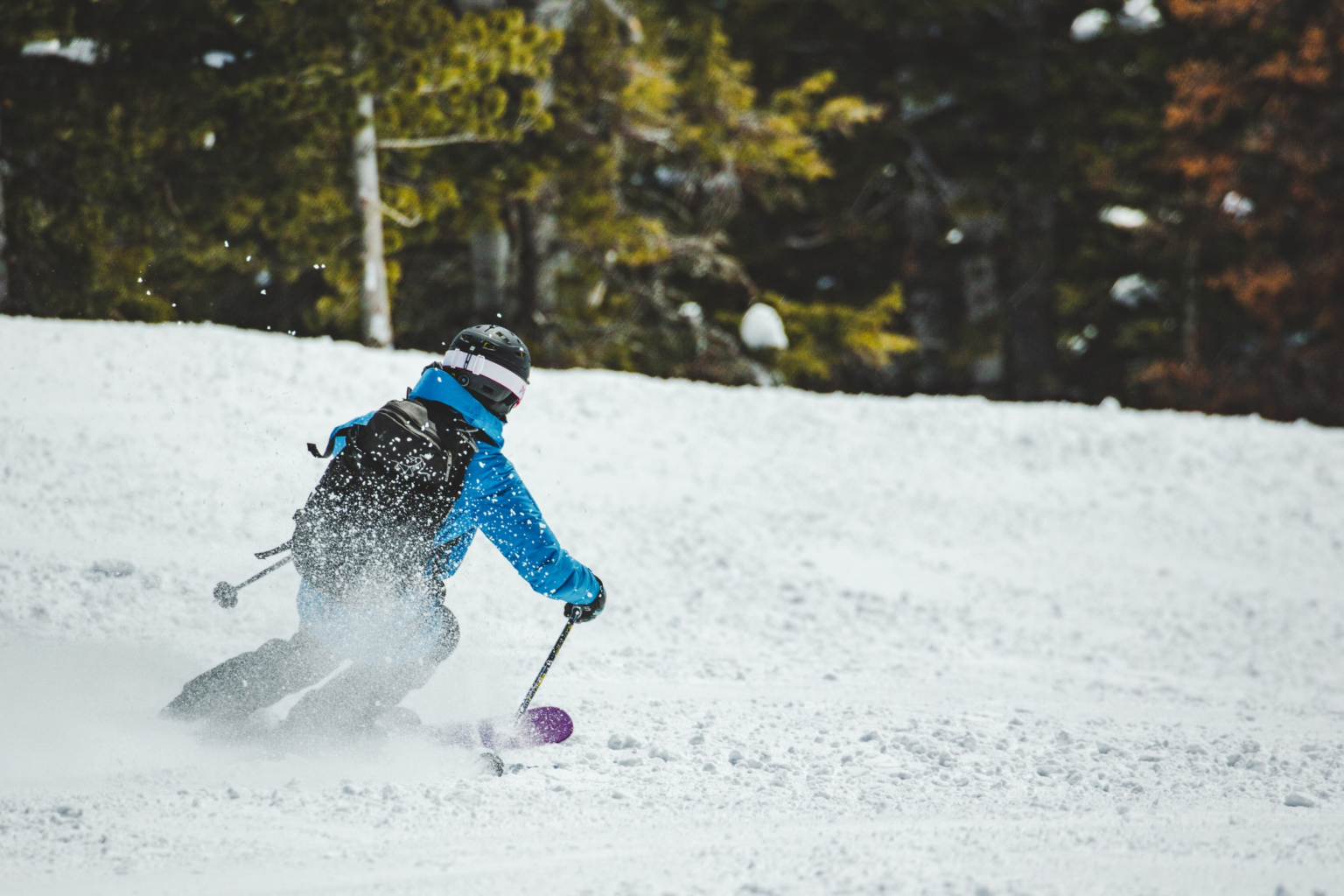 Crabbe Mountain in Canada - a person in a blue jacket skiing down a hill.