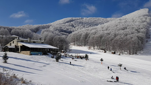 Winter scene at Vigla Pisoderi in Verno, Florina, Greece, featuring a bustling ski resort with ski lifts in operation amidst stunning snow-covered scenery.