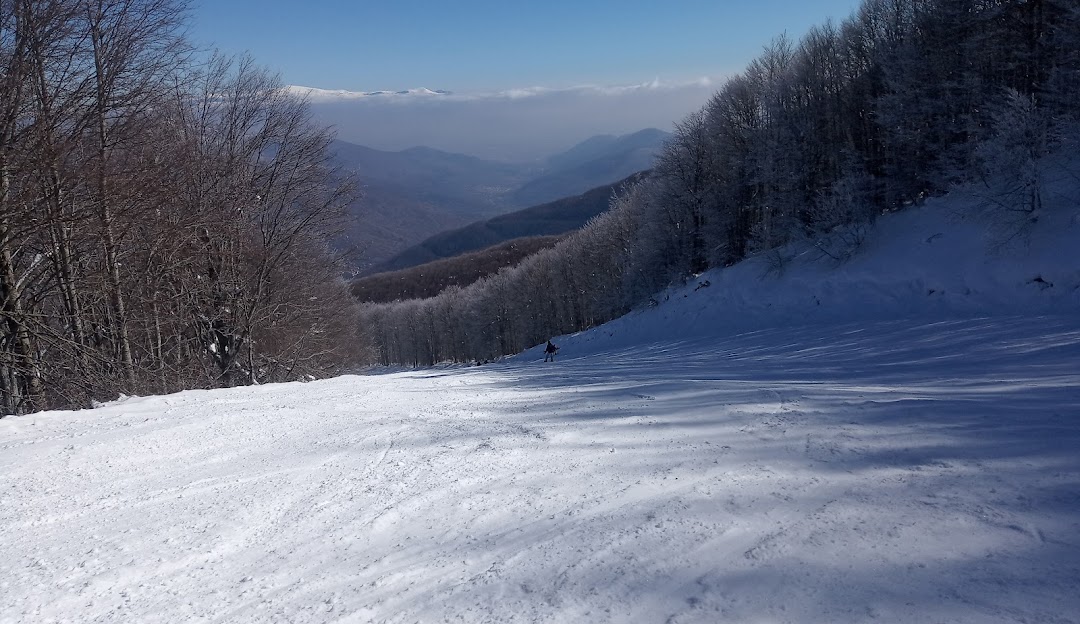 A winter sports scene at Vigla Pisoderi in Verno, Florina, Prespes, Western Macedonia, Greece. The image showcases a well-equipped ski resort nestled among snow-covered slopes, under a stunning winter sky.