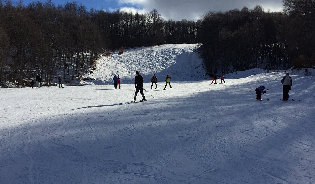 Vigla Pisoderi in Greece - a group of people skiing down a snowy slope.