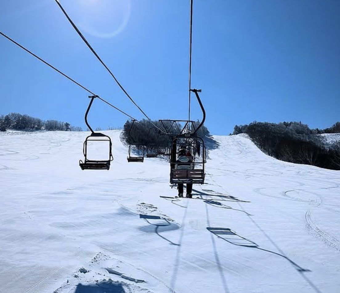 Tengendai in Japan - a ski lift going up a snowy slope.