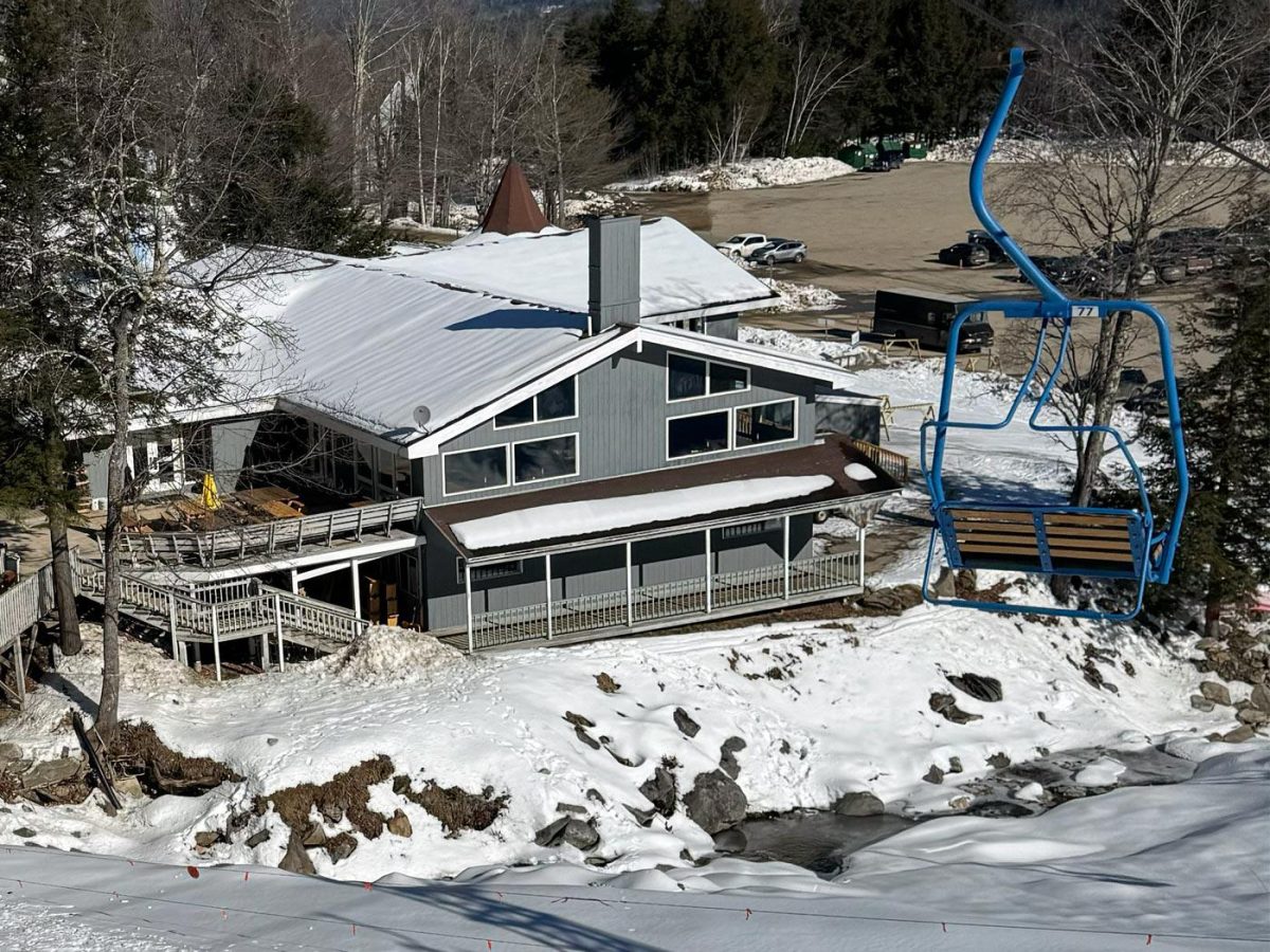 Tenney Mountain in USA - a house with snow on the ground and a ski lift.