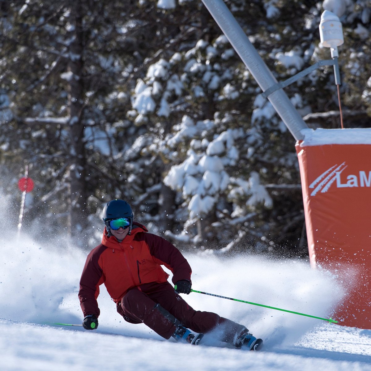 Muntanya de Masella in Spain - a man in a red jacket skiing down a hill.