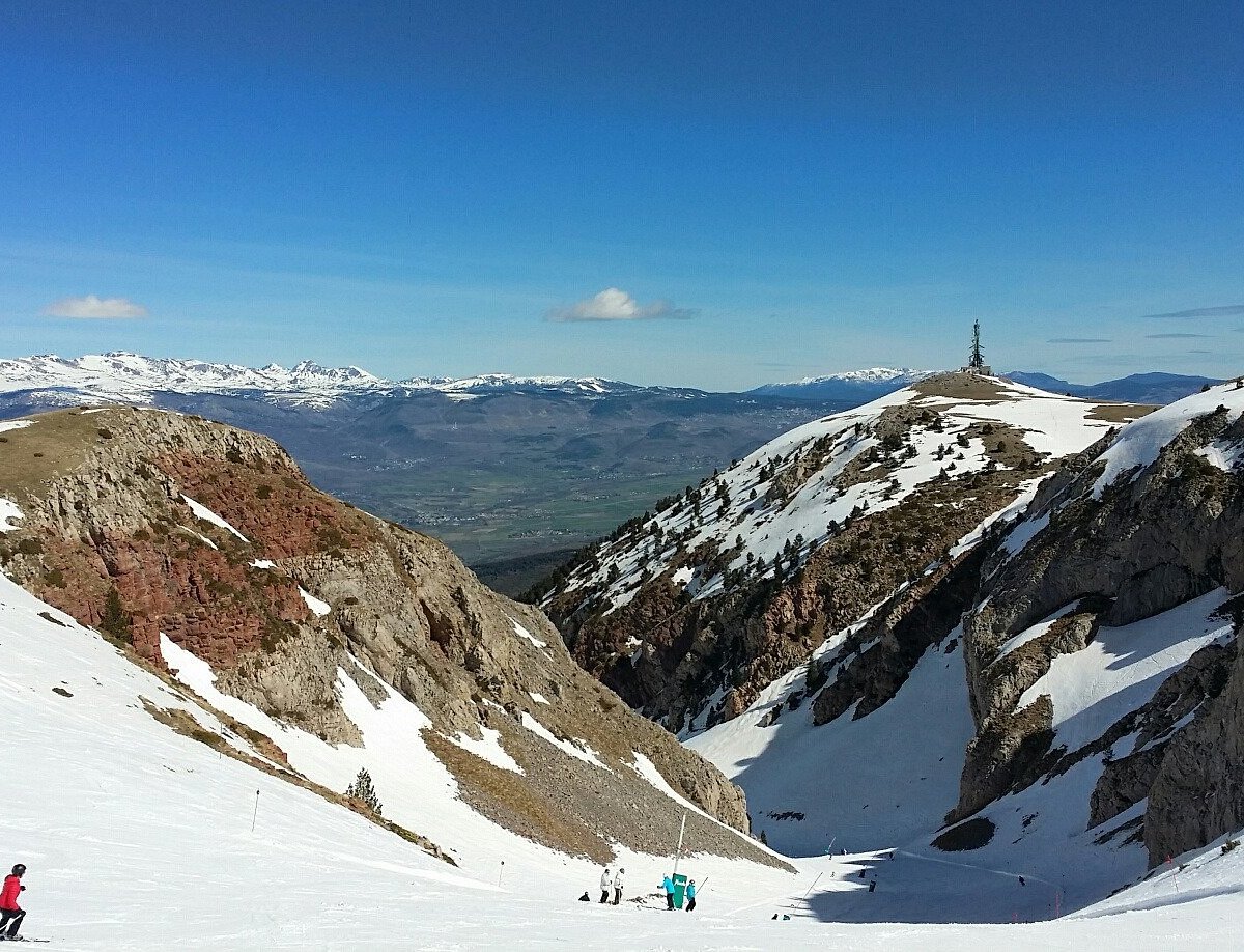 Muntanya de Masella in Spain - a group of people skiing down a snowy slope.