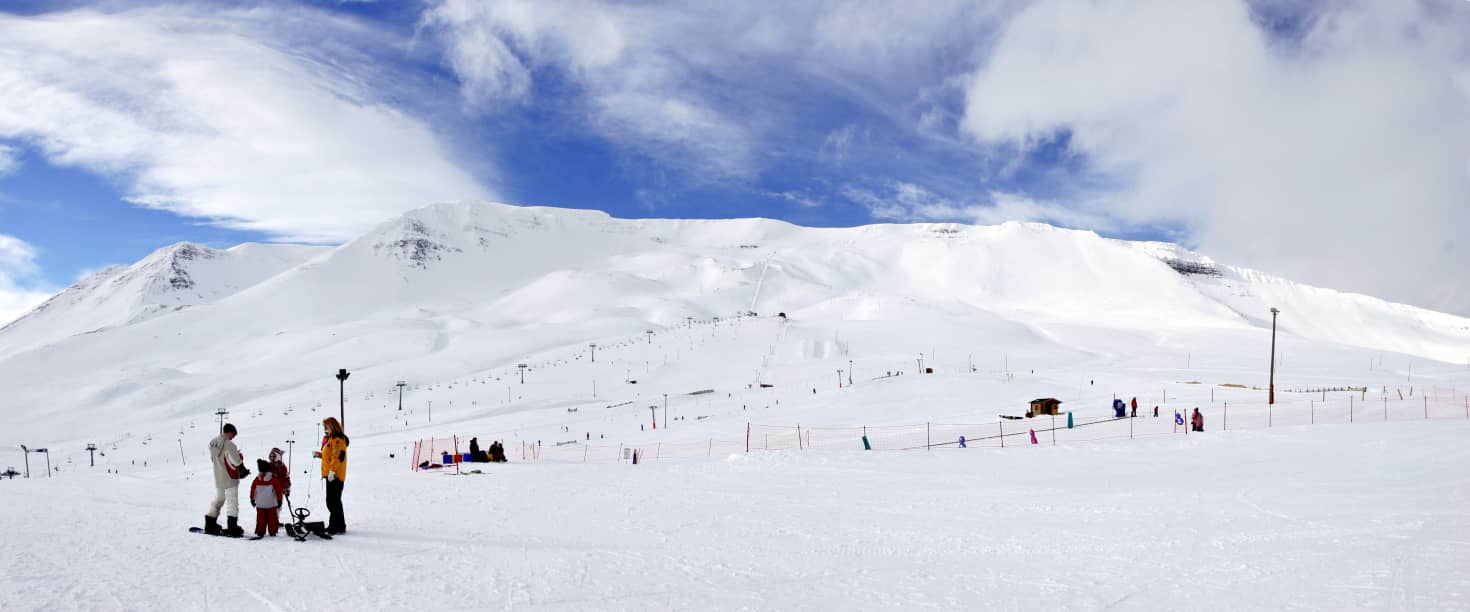 Hlíðarfjall in Iceland - a group of people standing in the snow.
