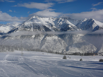 Winter sports scene at Sportbahnen Eischoll Augstbordregion, featuring a ski resort, a quaint challet, and picturesque snow-covered slopes in Valais, Switzerland.