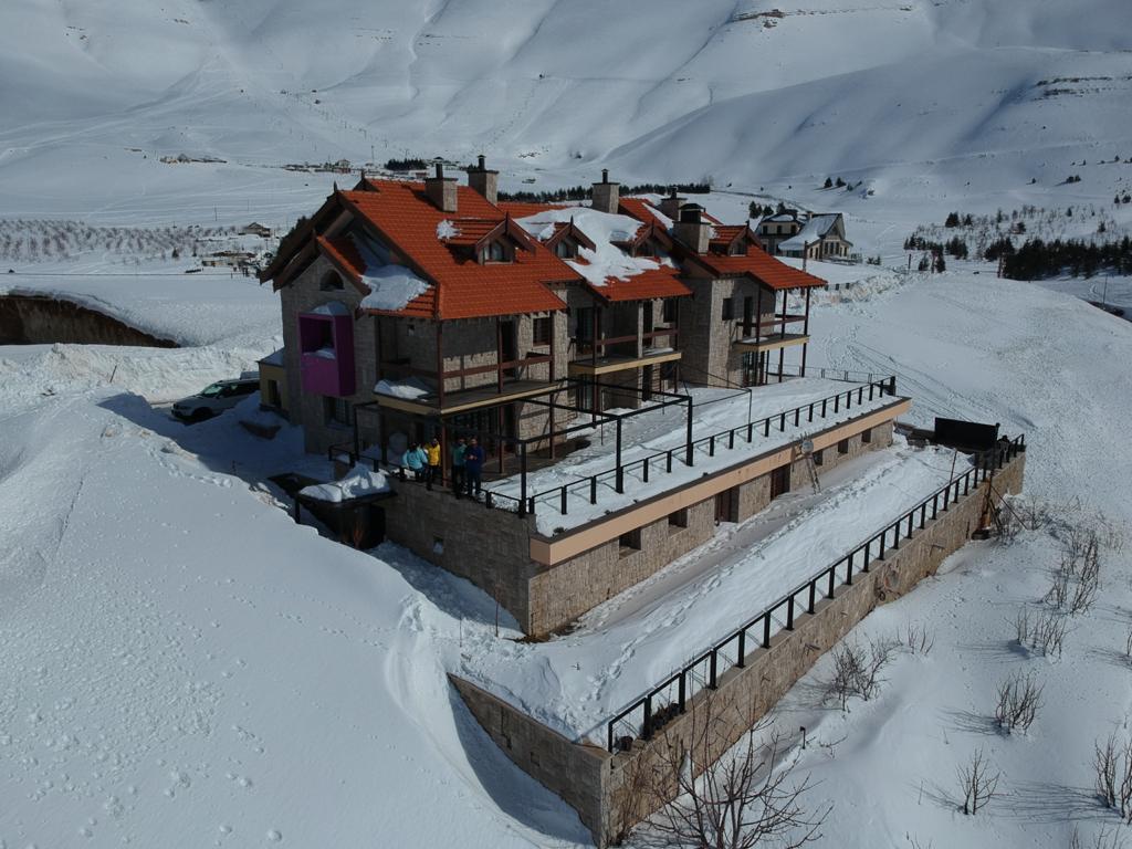 Cedars Bsharri in Lebanon - a house in the mountains covered in snow.