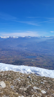 A charming chalet nestled in the snow-capped mountains of Céüze 2000 Gap in the Hautes-Alpes region of France under a bright sun signaling a perfect day for winter sports.