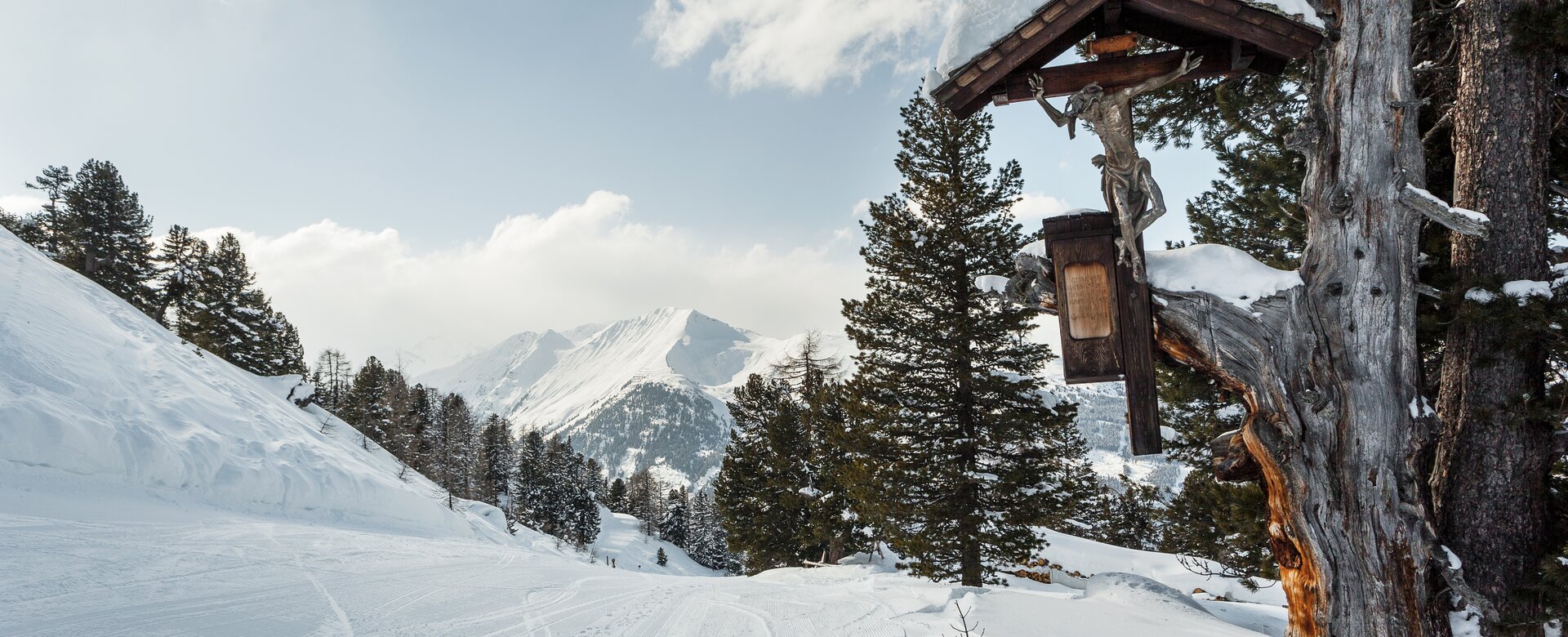 Graukogel – Bad Gastein in Austria - a cabin in the snow with trees and mountains in the background.