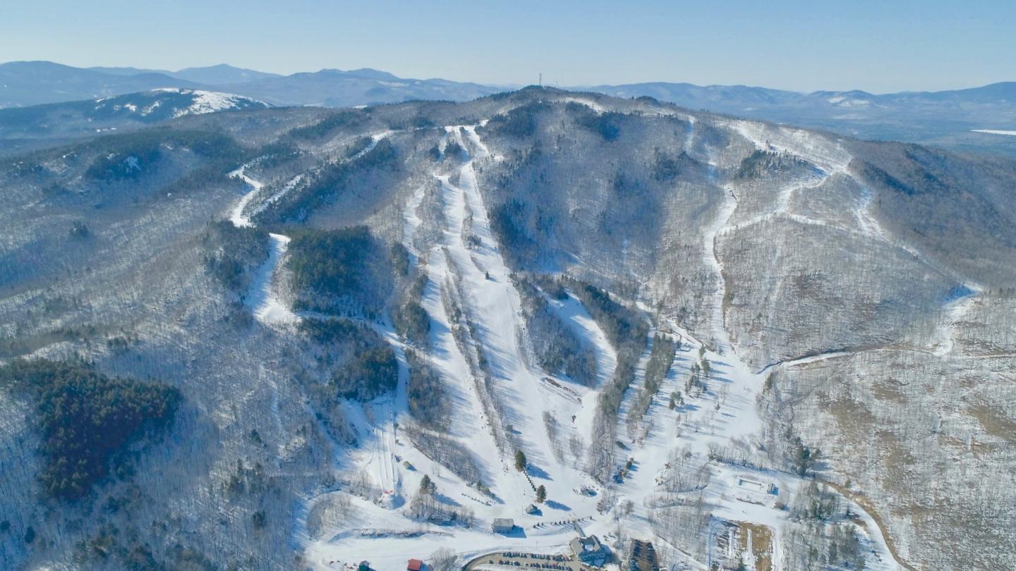 Black Mountain of Maine in USA - snow covered mountains in the distance.