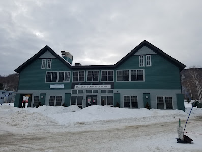 View of Black Mountain of Maine a winter sports centre in Rumford Maine featuring a cozy lodge and ski resort amidst a snowy winter sports scene.