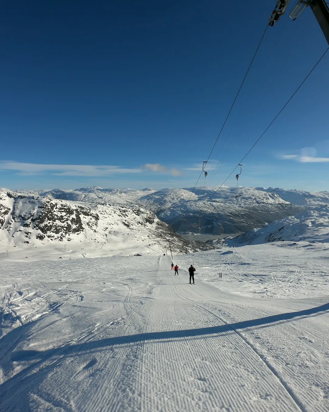Røldal in Norway - a person is skiing down a snowy slope.