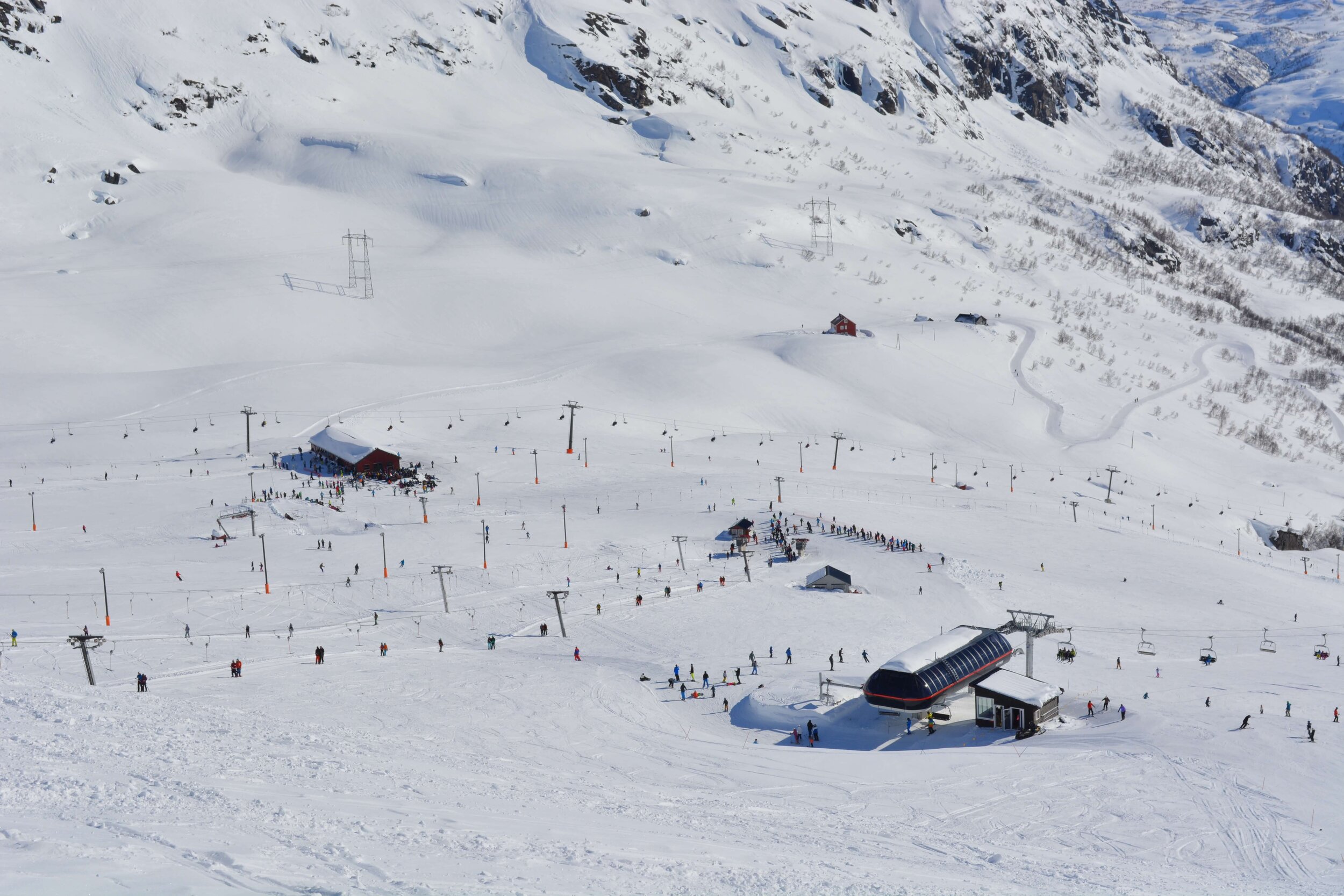Røldal in Norway - a group of people skiing down a snowy mountain.