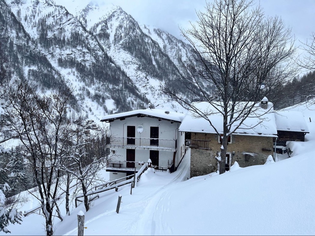 Prali in Italy - a house in the mountains covered in snow.