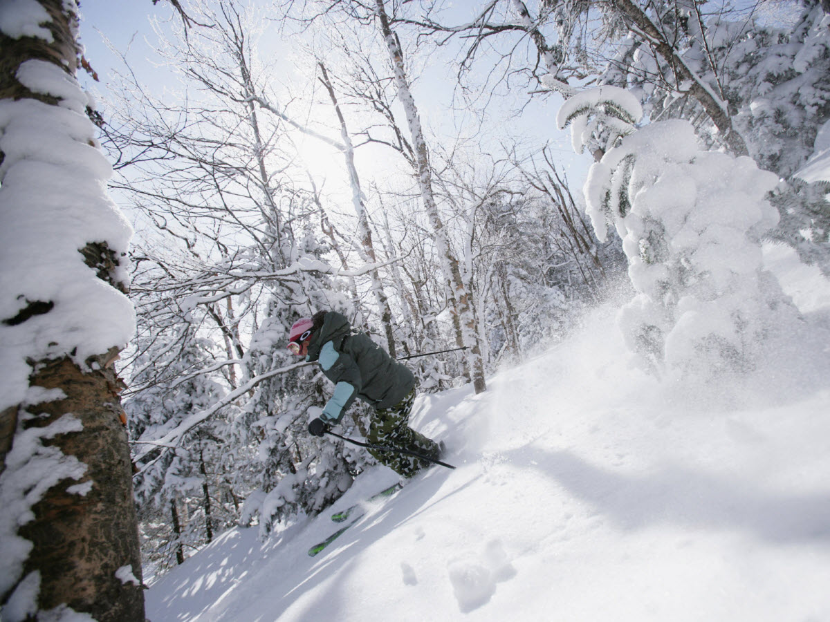 Jiminy Peak in USA - a person riding a snowboard down a snowy slope.