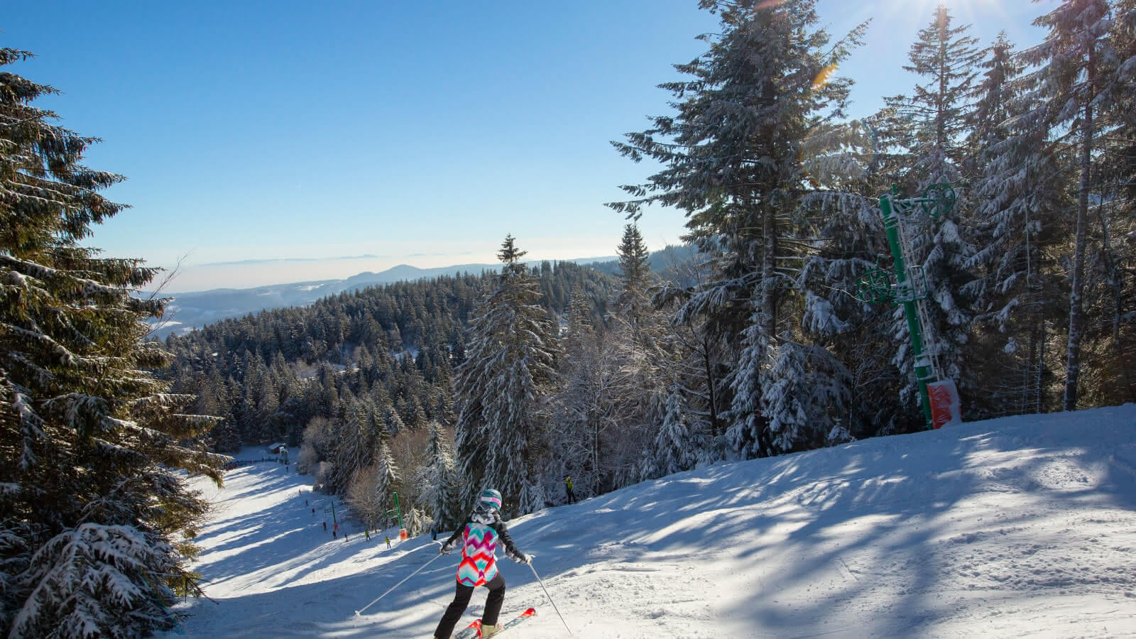 Lac Blanc in France - a person is skiing down a snowy hill.