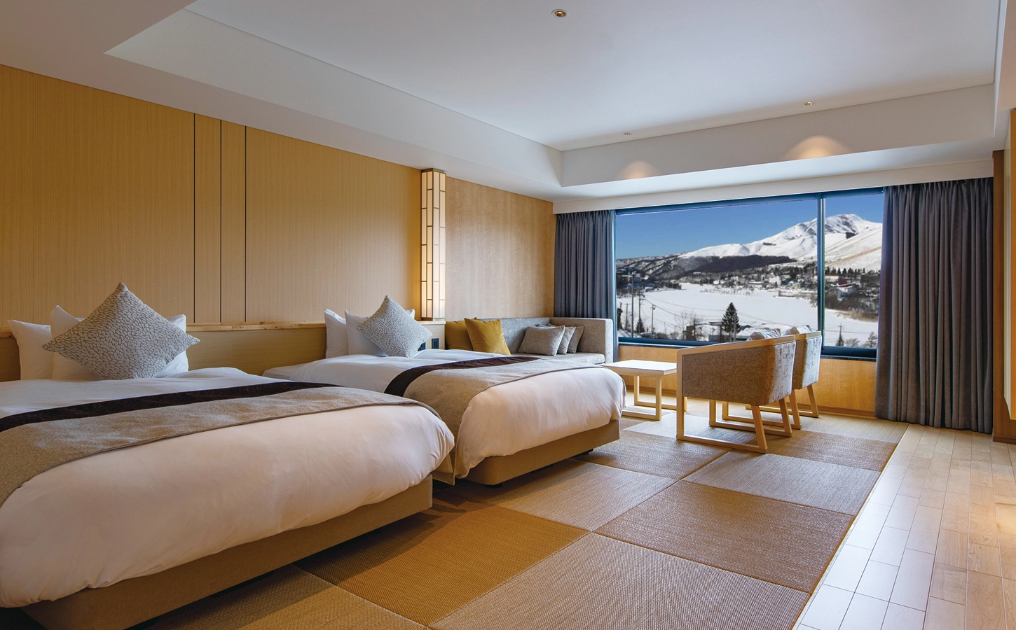 Shirakaba 2in1 in Japan: two beds in a hotel room with a view of the mountains.