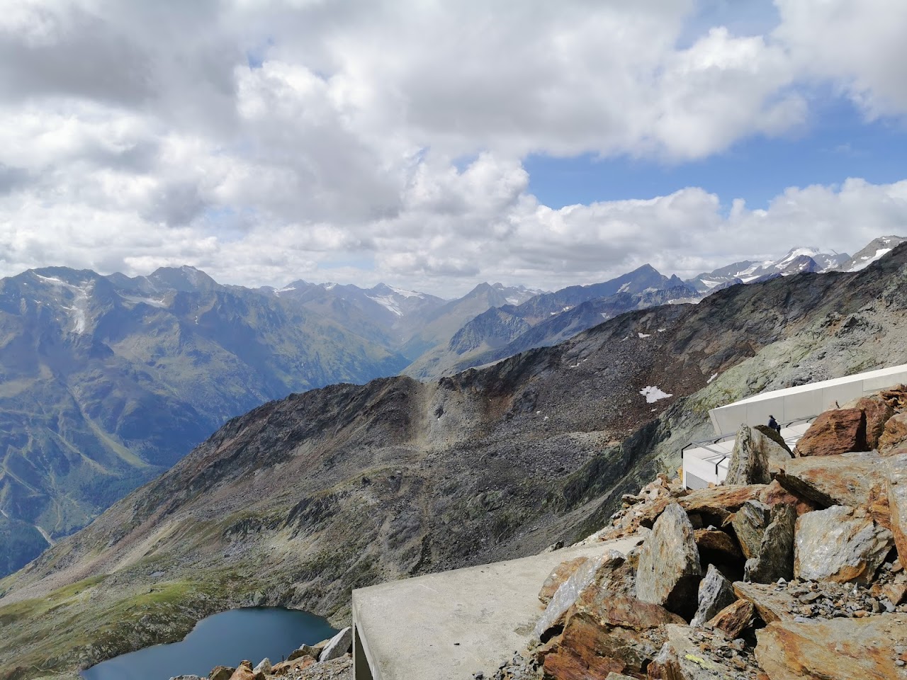 Serlesbahnen Mieders Bergbahn Bergstation in Austria - a view from the summit of a mountain with a lake in the fore.
