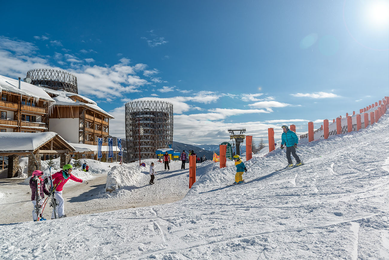 Katschberg in Austria - a group of people skiing down a snowy slope.