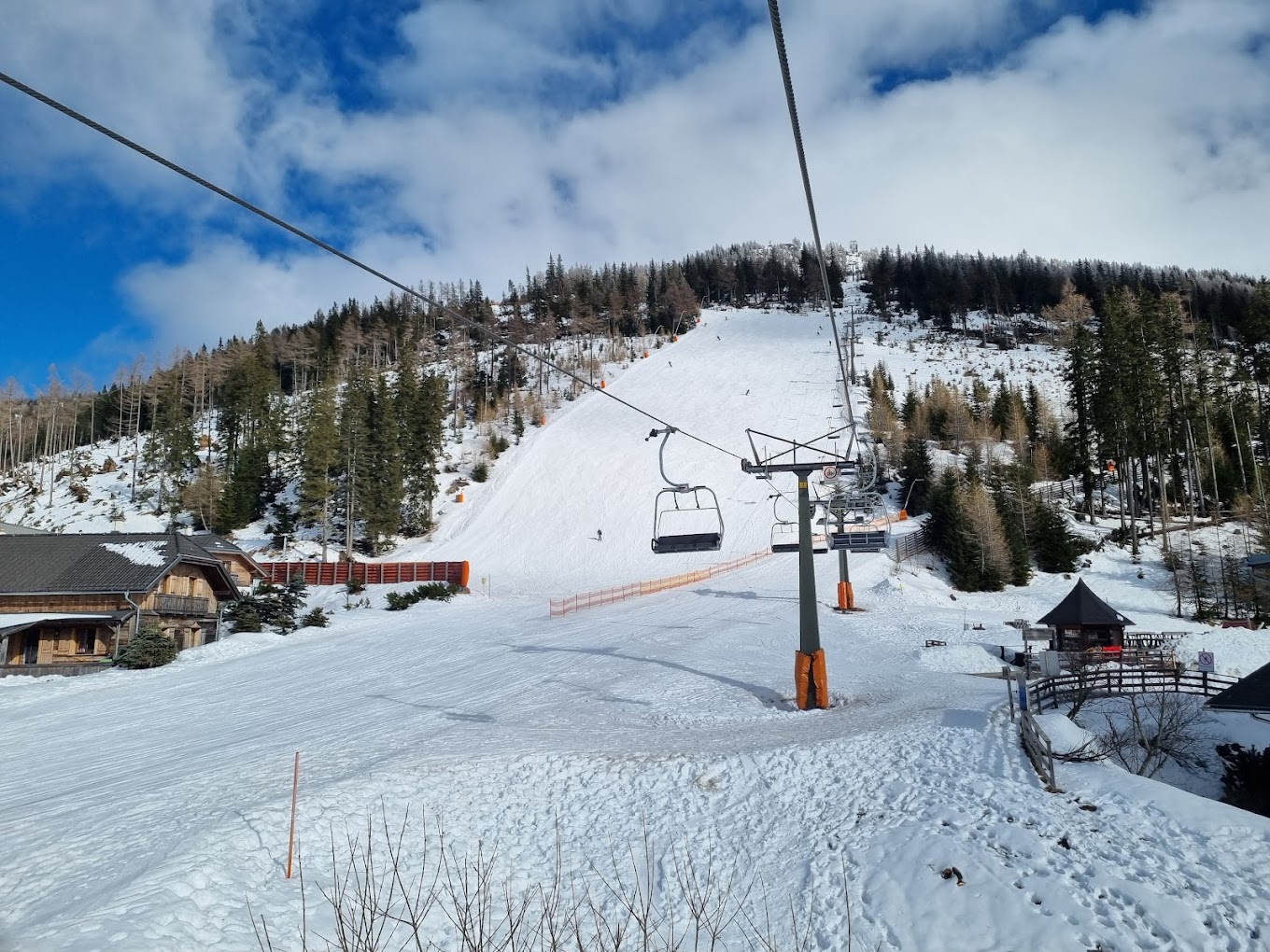 Katschberg in Austria - a ski lift going up a snowy slope.