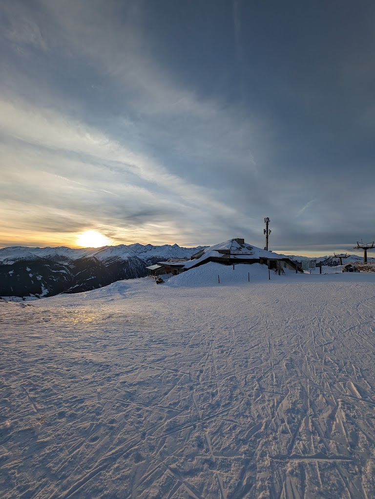 Katschberg in Austria - the sun is setting on the snow covered ground.