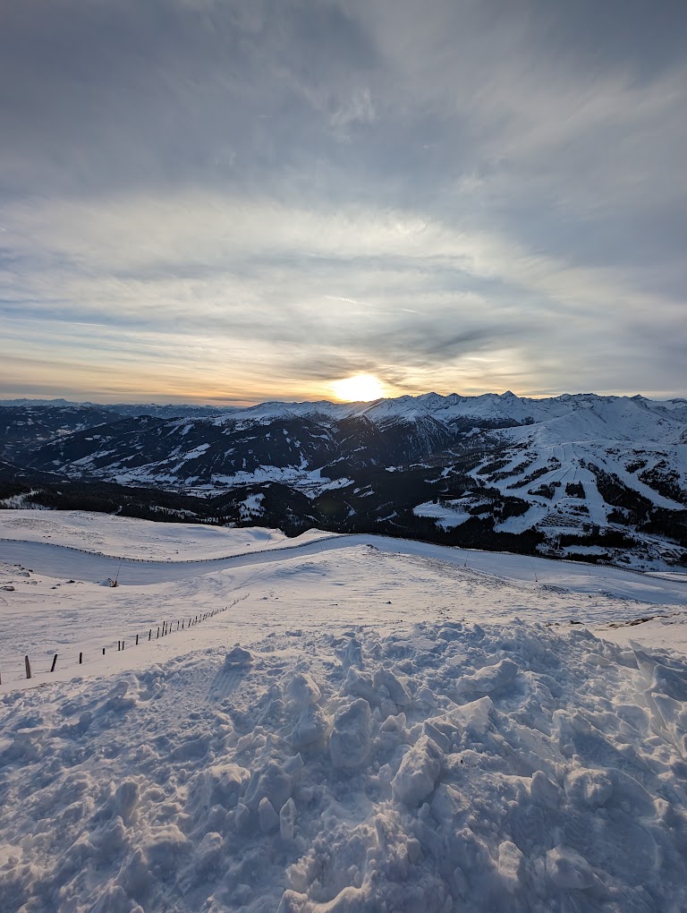 Katschberg in Austria - the sun is setting over the snowy mountains.