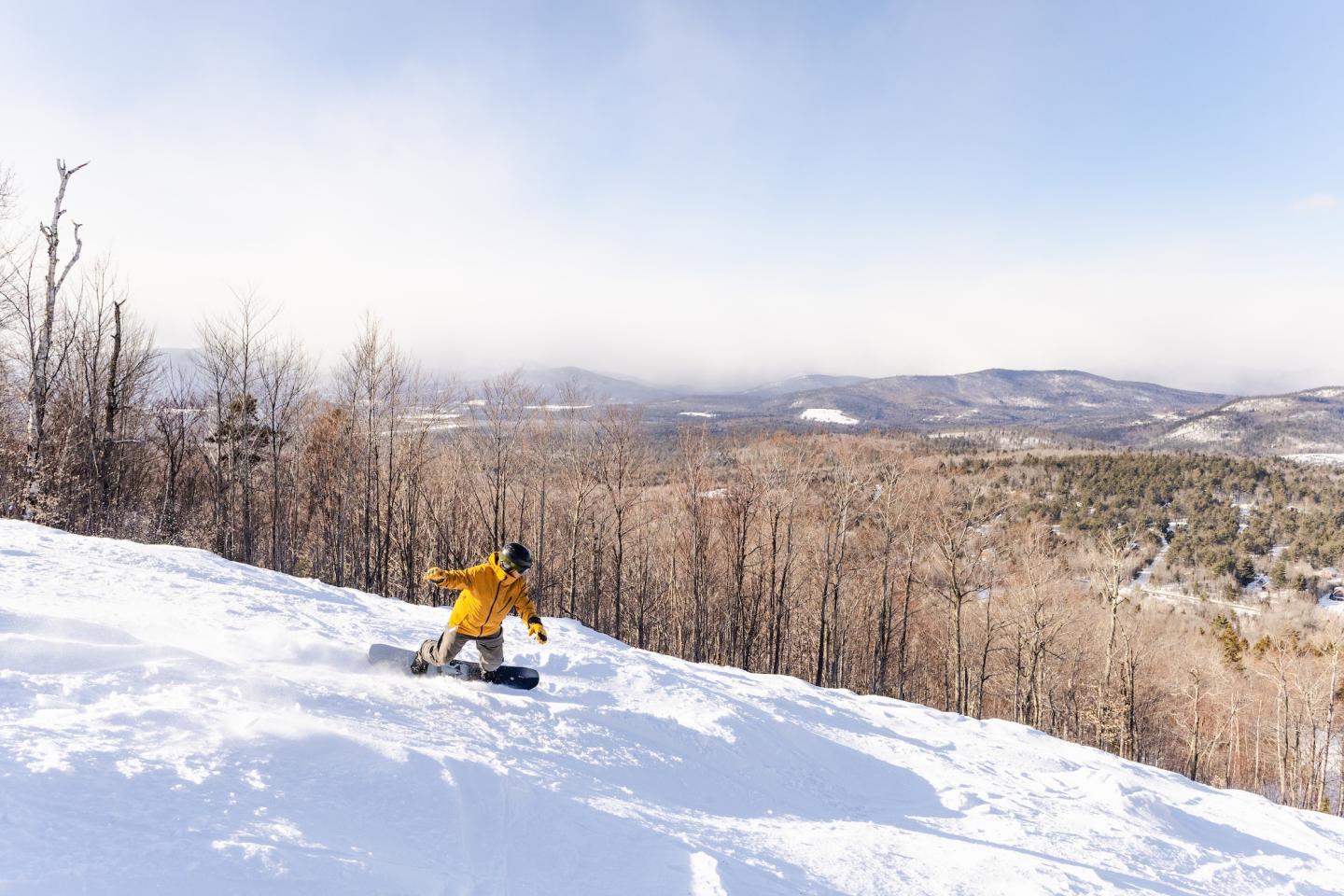 Mt Abram in USA - a person on a snowboard in the snow.