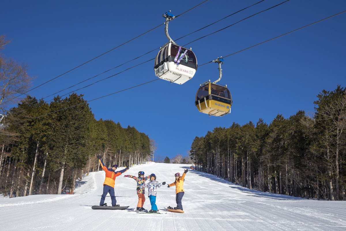 Mt. Jeans Nasu in Japan - a couple of people riding ski boards on a ski slope.