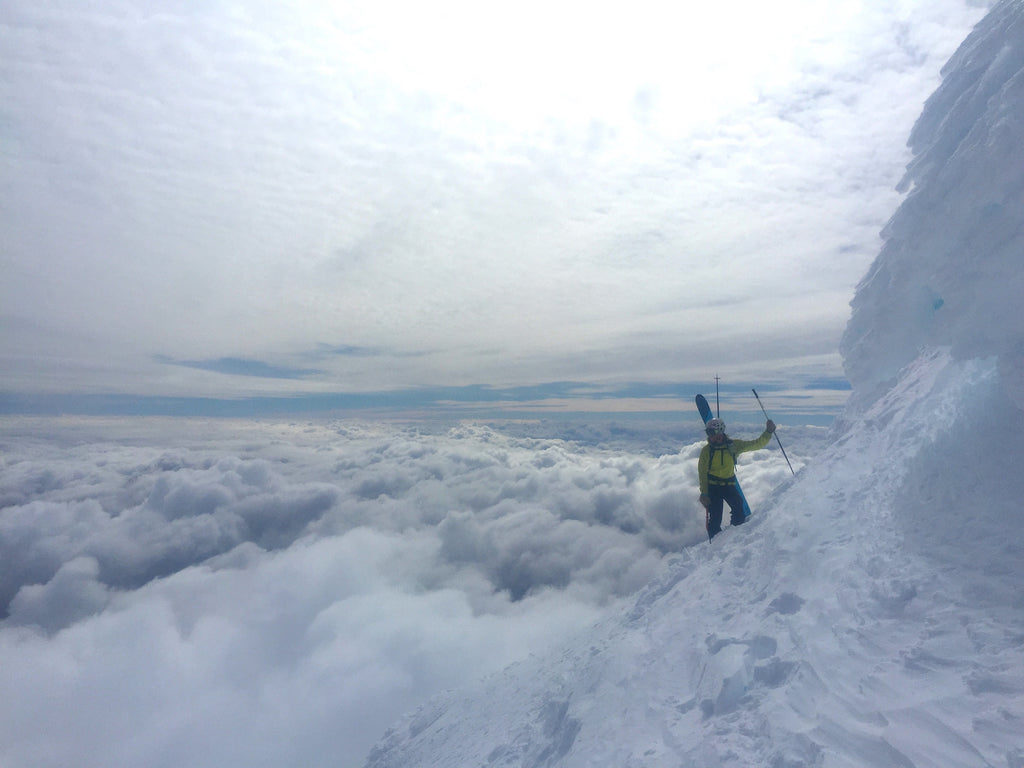 Osorno in Chile - a person standing on top of a snow covered mountain.