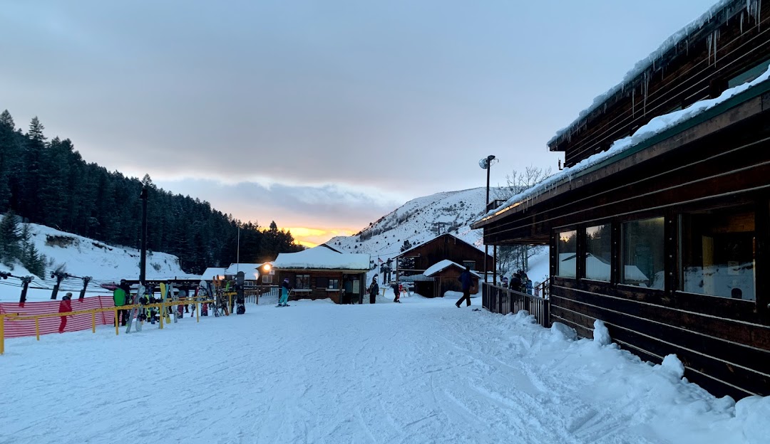 Picture capturing a winter sports scene at Kelly Canyon Ski Resort, Ririe, Idaho, featuring radiant winter scenery filled with snow covered slopes and trees.